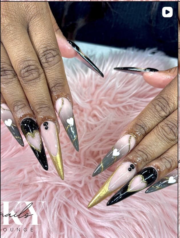 Black and gold stiletto nails with hearts
