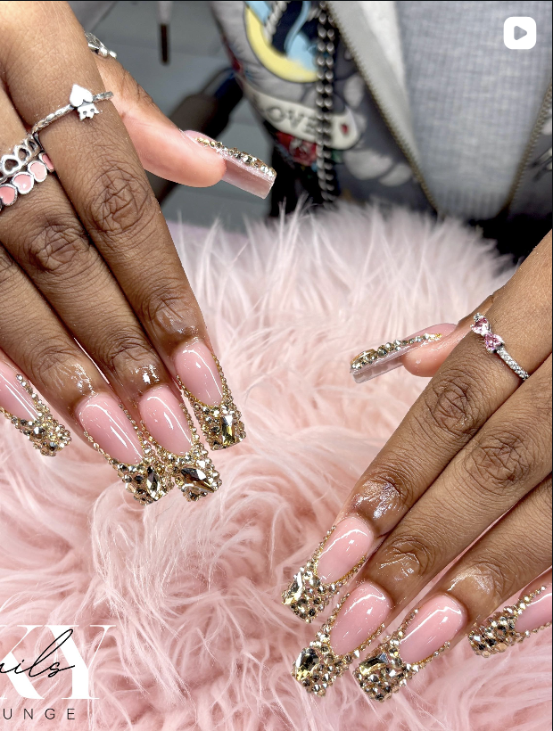 Pink nails with gold gem accents