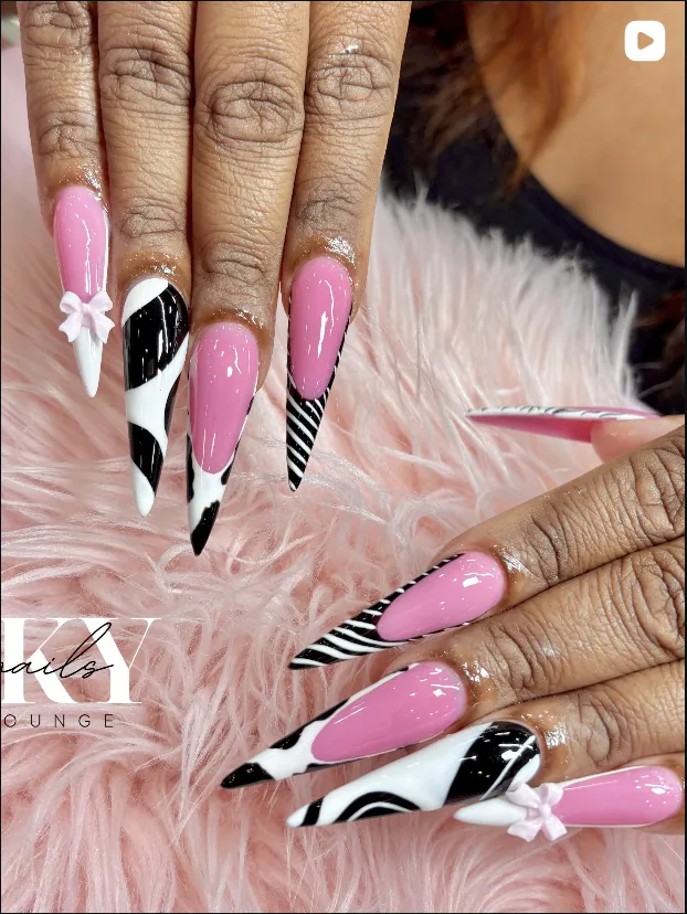 Pink and cow print stiletto nails