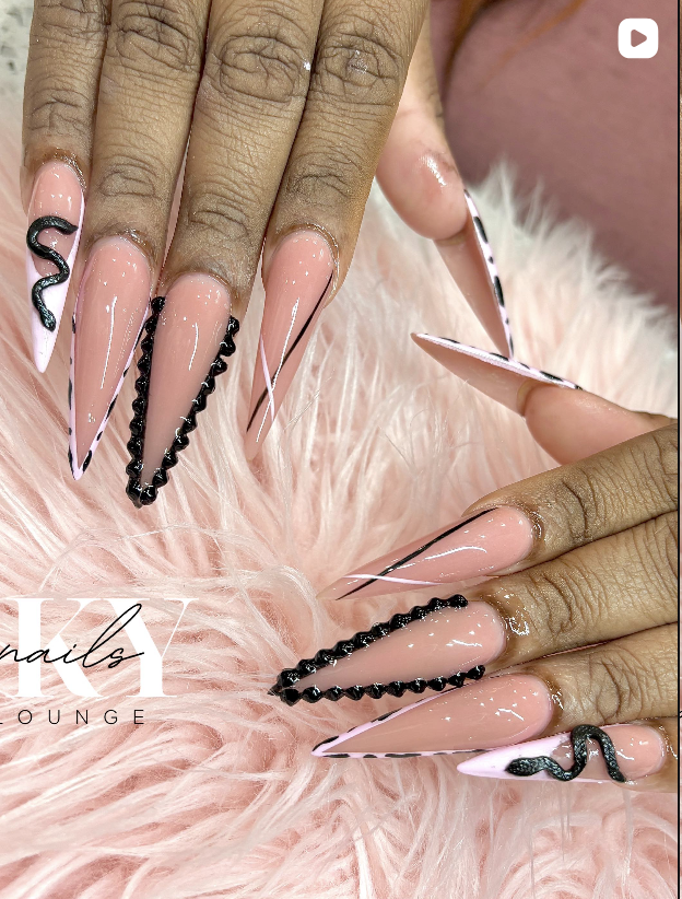 Snake design stiletto nails with black accents