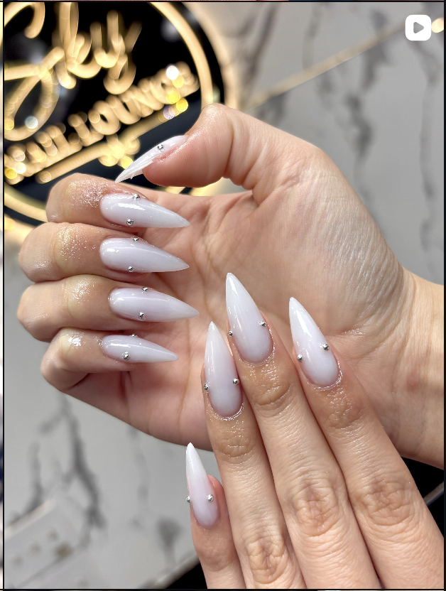 White stiletto nails with gem details
